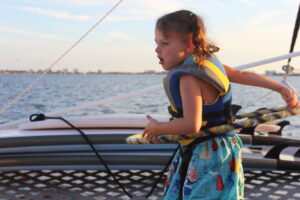 Girl in life jacket on boat