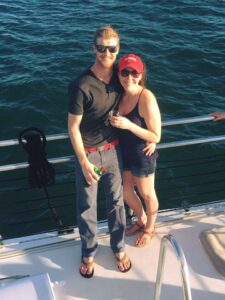 Happy couple aboard Sail Wild Hearts Sunset Cruise
