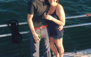 Happy couple aboard Sail Wild Hearts Sunset Cruise